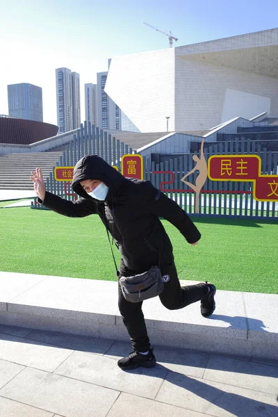 man in suit with a bag of arms