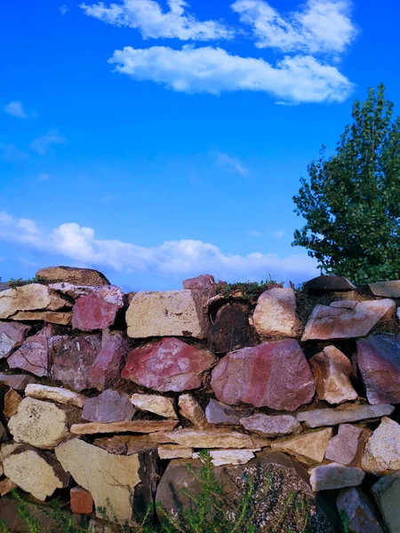 a pile of stone logs on the background of the forest