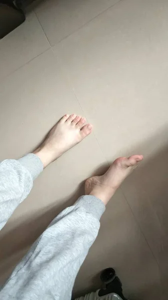 feet of a woman lying on the floor
