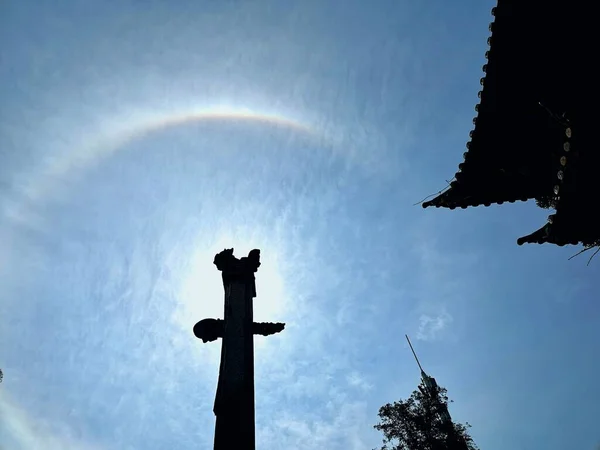 silhouette of a man with a cross on the background of the sky