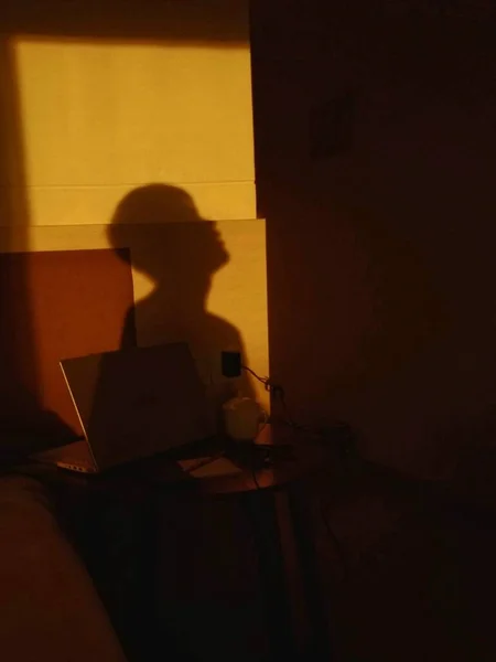 silhouette of a man in a black dress with a laptop