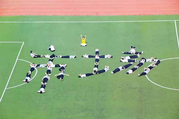 group of people playing football at the stadium