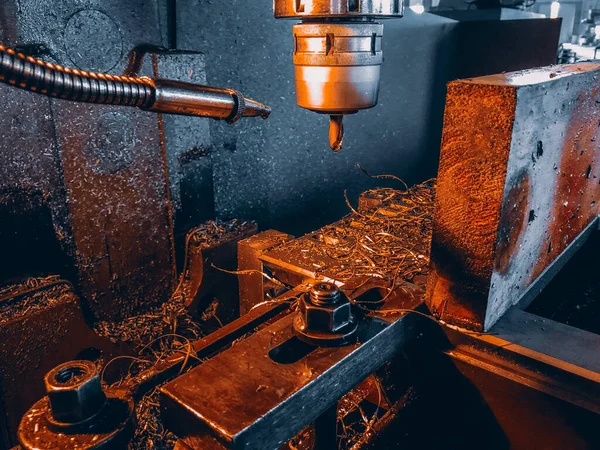 industrial metal with a grinder and a large machine