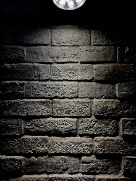 old brick wall with a black background