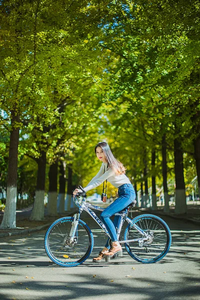 young woman riding bicycle in the park