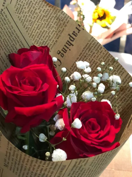 roses and a book on a background of a red rose