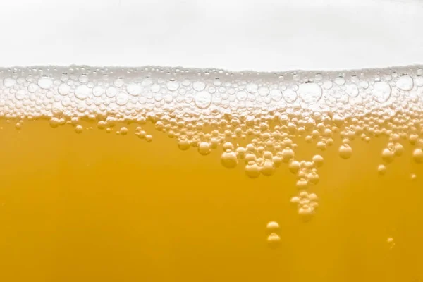 beer glass with bubbles on white background