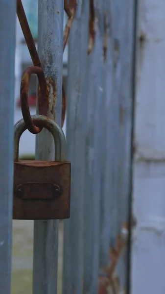 old rusty padlock on the background of the door