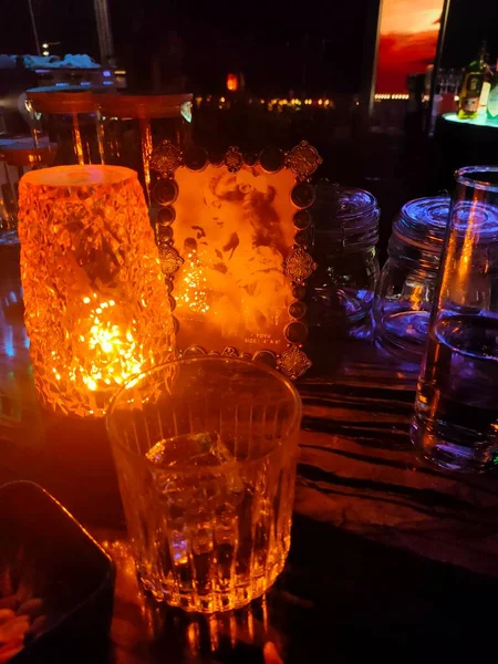 a glass of red wine on a bar counter