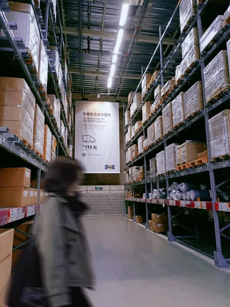 warehouse shelves with boxes in the background