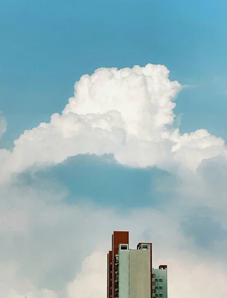 modern city building with clouds