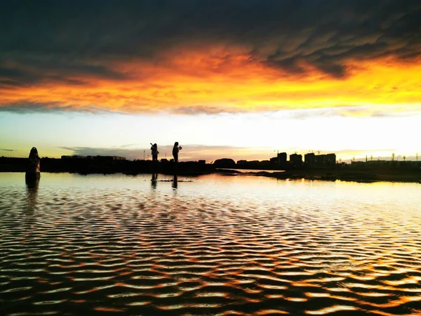 silhouette of a man and woman on the beach