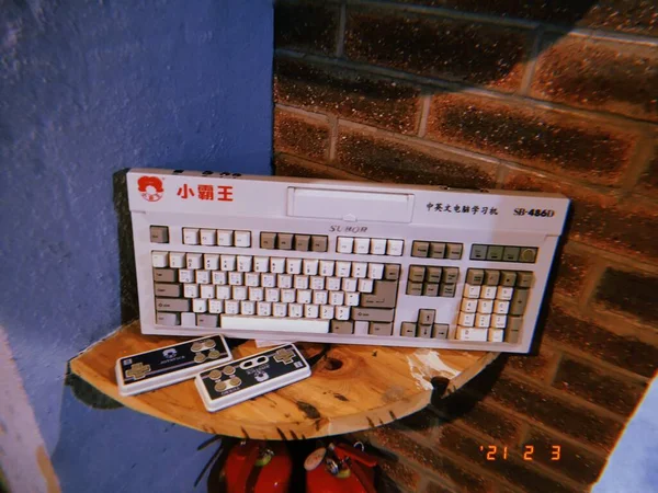 the computer keyboard with a laptop and a typewriter