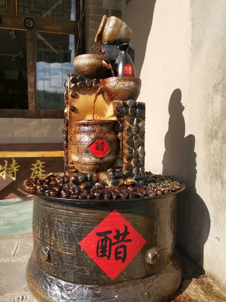 old rusty metal kettle with a red pepper