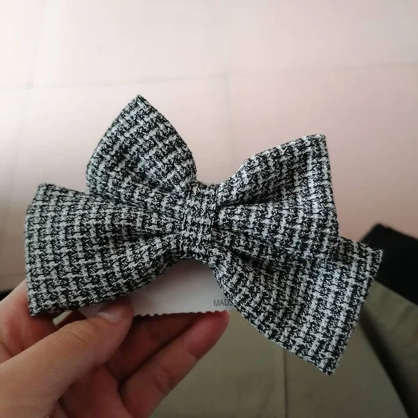 man's hand with bow tie and ribbon on white background