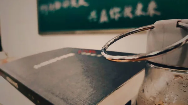 close up of a blackboard with a white chalk on a table