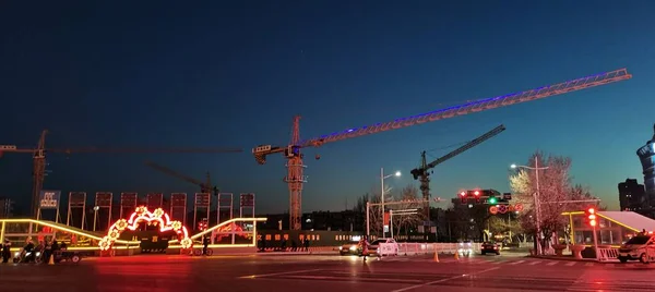 construction cranes and building at night