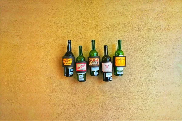 bottles of different types of wine on a wooden background.