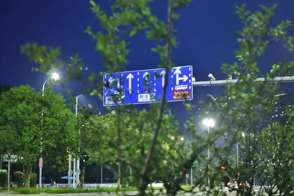 street sign with a lot of people signs and trees