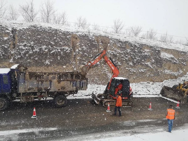 excavator in the snow