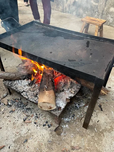 a closeup shot of a blacksmith\'s hands on a fire