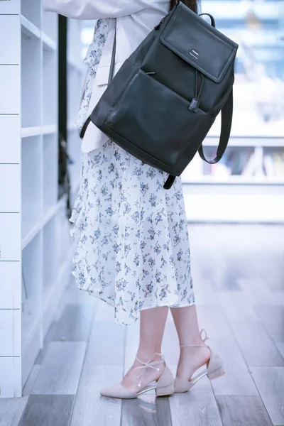 fashion model in a dress with a handbag