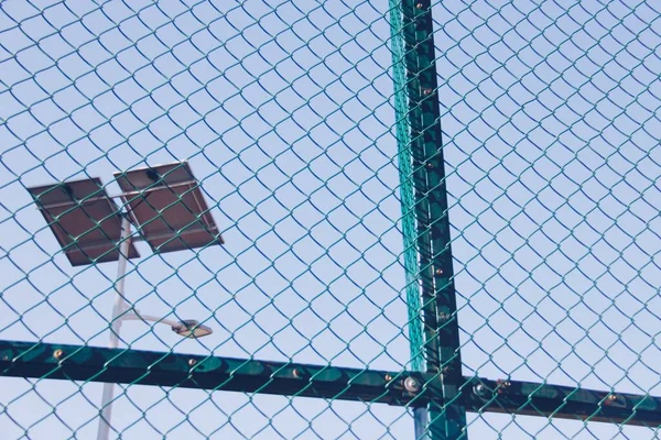a vertical shot of a fence with a net