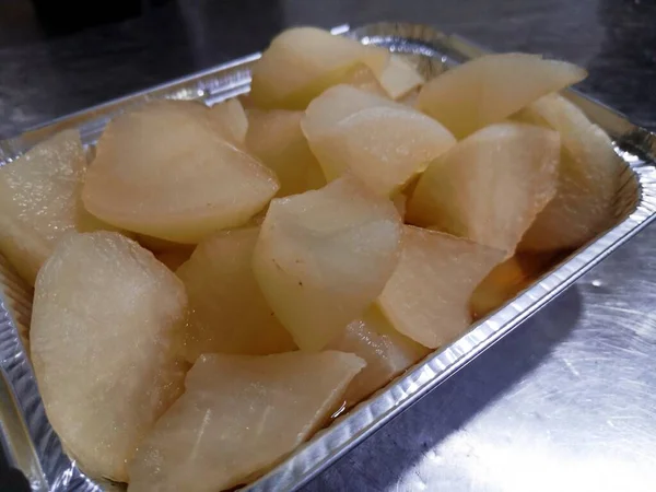 fresh raw potatoes in a pan