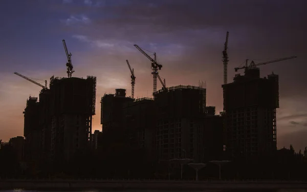 construction site with cranes and buildings