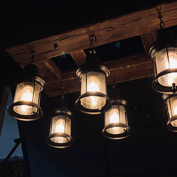 old wooden ceiling lamp on a dark background