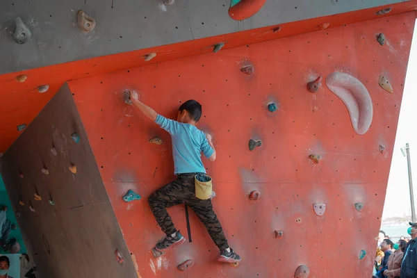 climber rock climbing on the wall in a modern gym.