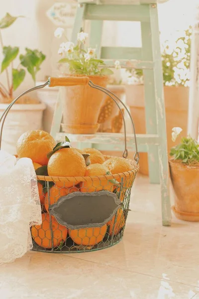 orange and white basket with oranges and fruits