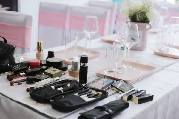 set of different makeup products on table in room