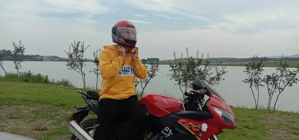 young woman riding motorcycle in the mountains