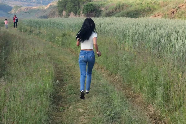 young woman walking in the field