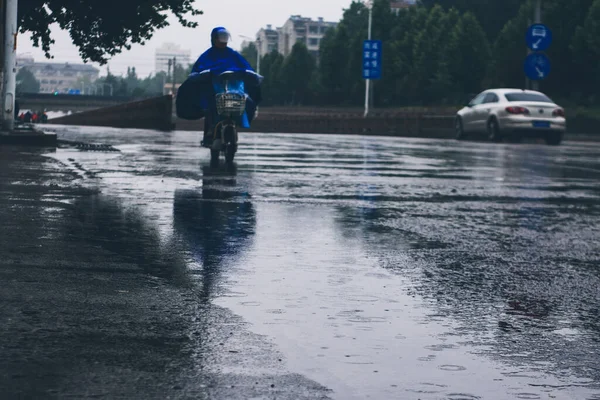 man riding a motorcycle in the city