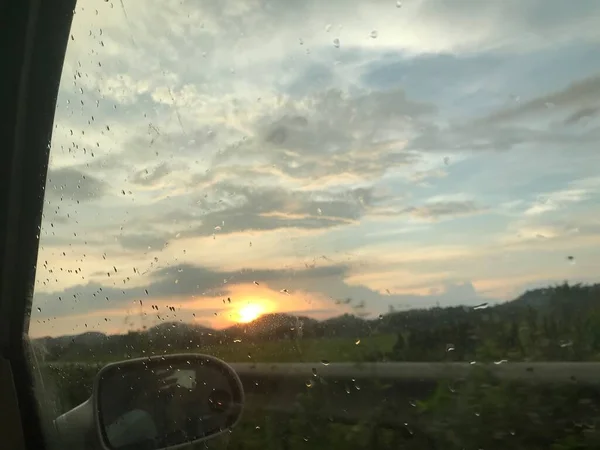 sunset over the window of the car