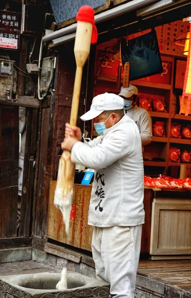 worker in a protective uniform and a mask in the factory