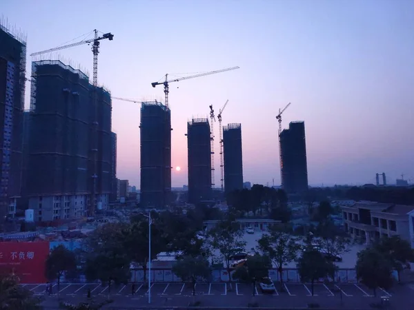 construction site with cranes and buildings