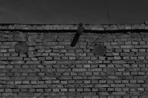 old brick wall with a black and white background