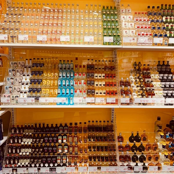 shelves with different color bottles in the store
