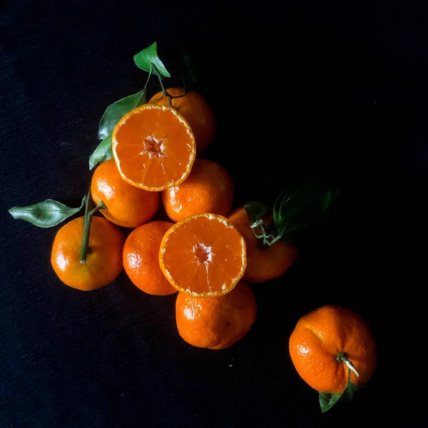 fresh oranges on a black background