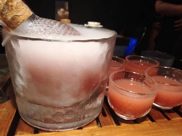 cocktail with ice and salt on a wooden table