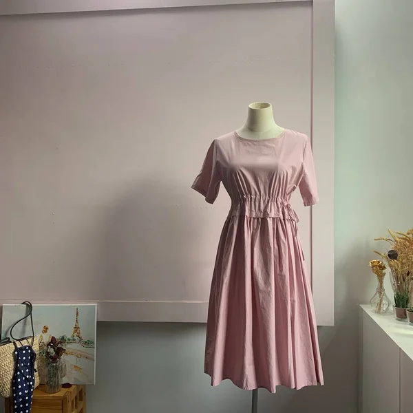 beautiful woman\'s dress on a mannequin in a room