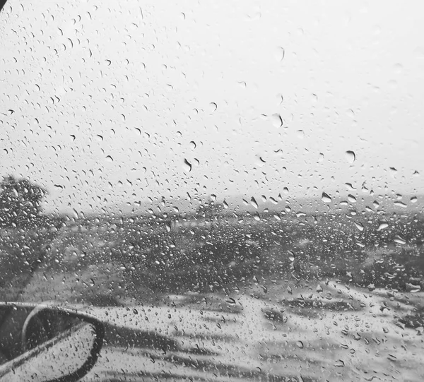 rain drops on glass, wet window, rainy weather, raindrops on the road, background