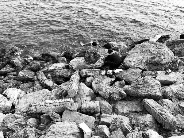 black and white sea water with rocks and stones