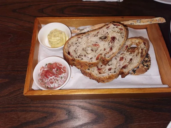 bread with jam and butter on a wooden board