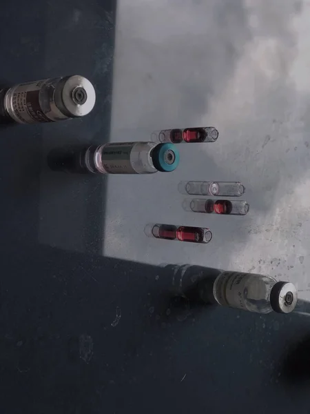 a closeup shot of a syringe with a vaccine on a black background