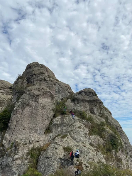 man climbing the mountain in the mountains