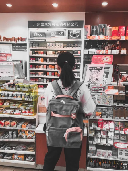 young woman with shopping bags in the supermarket